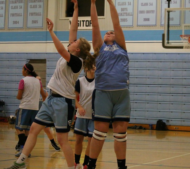 Southeast junior Katharina Jens and senior Maggie Renn reach for a rebound at this week’s Blue-White Scrimmage.  On Friday, Southeast hosts Oswego.  The Varsity Girls play in the East Gym at 6 p.m.  The Varsity Boys game follows.