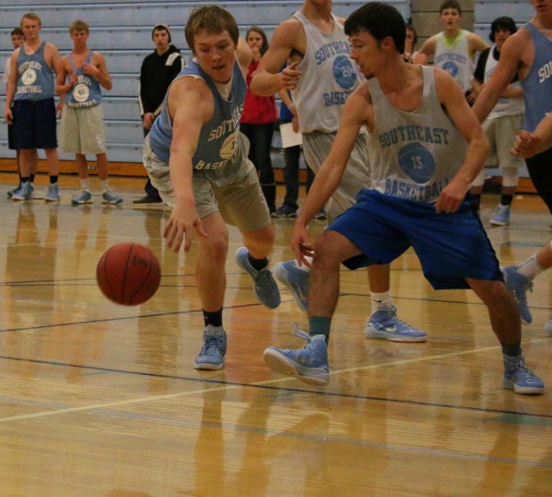Southeast seniors Riley Ulery and James Zimmerman fight for a loose ball at this week’s Blue-White Scrimmage.  The Southeast Boys slogan this year is “Dirty Tough” and the team’s coach says it’s a reminder to do all of the little things it takes to win.