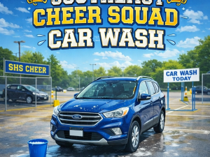 Cheerleaders washing a blue car at Southeast High School fundraiser car wash event.