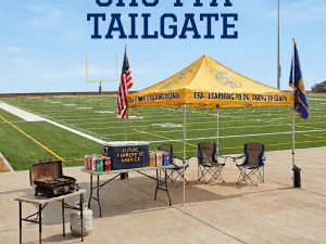FFA Chapter 436 booth with barbecue, cornhole, flags, and signs reading “Learning to Do, Doing to Learn” and “Future Farmers of America.”